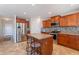Kitchen includes stainless appliances, center island, wood cabinets, and breakfast bar seating at 5305 E Silverbell Rd, San Tan Valley, AZ 85143