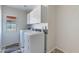 Bright laundry room equipped with washer, dryer, and built-in upper cabinets at 5305 E Silverbell Rd, San Tan Valley, AZ 85143