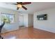 Bright living room featuring hardwood floors, ceiling fan, and a large window at 5305 E Silverbell Rd, San Tan Valley, AZ 85143