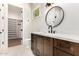 Elegant bathroom featuring a modern vanity with quartz countertop and a view into the walk-in closet at 5440 E Calle Camelia --, Phoenix, AZ 85018