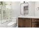 Bright bathroom with tub-shower, modern vanity, and stylish fixtures, plus natural light from the window at 5440 E Calle Camelia --, Phoenix, AZ 85018