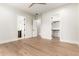Open bedroom with hardwood floors and multiple entryways to a bathroom and closet at 5440 E Calle Camelia --, Phoenix, AZ 85018