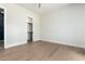 Minimalist bedroom with hardwood floors, bright white walls, and a walk-in closet at 5440 E Calle Camelia --, Phoenix, AZ 85018