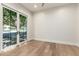 Bright bedroom with wood floors and large glass doors to the backyard with a seating area at 5440 E Calle Camelia --, Phoenix, AZ 85018
