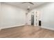 Bright bedroom featuring hardwood floors, a ceiling fan, a walk-in closet, and access to an ensuite bathroom at 5440 E Calle Camelia --, Phoenix, AZ 85018