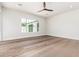 Bright bedroom features hardwood floors, a ceiling fan, and a large window at 5440 E Calle Camelia --, Phoenix, AZ 85018