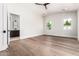 Bedroom featuring hardwood floors and ample natural light, with an ensuite bathroom and two windows at 5440 E Calle Camelia --, Phoenix, AZ 85018