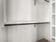Organized closet with dark-colored rods, white shelves, and hardwood floors at 5440 E Calle Camelia --, Phoenix, AZ 85018