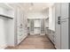 Spacious walk-in closet with custom shelving, drawers, and ample storage, plus bright lighting and hardwood floors at 5440 E Calle Camelia --, Phoenix, AZ 85018