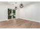 Elegant dining area with wood floors, modern chandeliers, and large windows to the backyard at 5440 E Calle Camelia --, Phoenix, AZ 85018