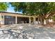 Stunning home exterior with a three-car garage, brick driveway and lush tree providing ample shade at 5440 E Calle Camelia --, Phoenix, AZ 85018