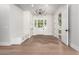 Inviting home foyer with hardwood floors, white walls, and an elegant chandelier over the front door at 5440 E Calle Camelia --, Phoenix, AZ 85018