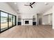 Spacious living room featuring a modern fireplace, built-in shelves, and sliding glass doors to the backyard at 5440 E Calle Camelia --, Phoenix, AZ 85018