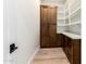 Spacious pantry with wooden cabinets, white shelves, white countertop and wood flooring at 5440 E Calle Camelia --, Phoenix, AZ 85018