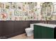 Stylish powder room decorated with botanical wallpaper, brass fixtures, and a green vanity at 5440 E Calle Camelia --, Phoenix, AZ 85018