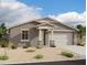Charming single-story home featuring neutral stucco, a two-car garage, and a covered entryway at 5516 W Piedmont Rd, Laveen, AZ 85339