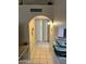 Hallway with tiled floors, arched doorway, and decorative lighting at 6711 W Osborn Rd # 138, Phoenix, AZ 85033