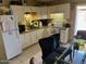 Cozy kitchen with white cabinets, updated appliances, and a dining area at 6711 W Osborn Rd # 138, Phoenix, AZ 85033