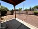 Spacious backyard with gravel groundcover, desert flora and brick pavers leading to gate at 6845 W Caron Dr, Peoria, AZ 85345
