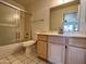 Bathroom featuring a shower with sliding glass doors, mirror, and light-wood cabinets at 6845 W Caron Dr, Peoria, AZ 85345