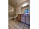 Bright bathroom featuring vanity sink, tiled floors, and a bathtub with sliding glass doors for easy maintenance at 6845 W Caron Dr, Peoria, AZ 85345