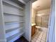 Hallway view leading into bath with shower, toilet, sink, mirror and storage at 6845 W Caron Dr, Peoria, AZ 85345