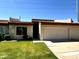Charming single-story home with a well-manicured lawn, garage and desert landscaping at 6845 W Caron Dr, Peoria, AZ 85345