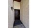 Inviting front entryway with a security door, exterior light fixture and textured walls at 6845 W Caron Dr, Peoria, AZ 85345