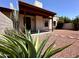 Charming single-story home with a covered porch, desert landscaping, and a stone walkway at 6845 W Caron Dr, Peoria, AZ 85345