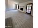 Inviting living room with a fireplace, carpet, and natural lighting at 6845 W Caron Dr, Peoria, AZ 85345
