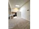 Airy living room featuring neutral carpet, white walls, and a pass through to the kitchen at 6845 W Caron Dr, Peoria, AZ 85345