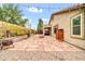 Spacious backyard featuring a stone patio, fire pit, outdoor kitchen, and string lights for relaxing evenings at 7425 N 75Th Dr, Glendale, AZ 85303