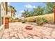 Backyard features a stone patio, stacked-stone fire pit, and lush landscaping at 7425 N 75Th Dr, Glendale, AZ 85303