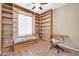 Bedroom with custom bookshelves, desk, and a cozy bench seat at 7425 N 75Th Dr, Glendale, AZ 85303