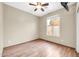 Empty bedroom with wood-look floors, ceiling fan, and a window providing natural light at 7425 N 75Th Dr, Glendale, AZ 85303