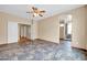 Bright bedroom with stylish flooring, ceiling fan, and an open doorway to an en-suite bathroom at 7425 N 75Th Dr, Glendale, AZ 85303
