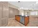 Kitchen island with a black countertop and wood cabinets next to the dining room at 7425 N 75Th Dr, Glendale, AZ 85303