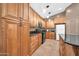Kitchen featuring black appliances, granite countertops, and wood cabinets at 7425 N 75Th Dr, Glendale, AZ 85303