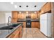 Fully equipped kitchen with granite countertops, wood cabinets, and a mosaic tile floor design at 7425 N 75Th Dr, Glendale, AZ 85303