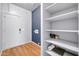 Convenient laundry area with storage shelves, wood-style flooring, and washer hookups at 7425 N 75Th Dr, Glendale, AZ 85303