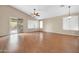 Bright living area with a vaulted ceiling, wood flooring, and sliding doors to the yard at 7425 N 75Th Dr, Glendale, AZ 85303