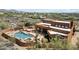 Stunning aerial view of an estate with a pool, spa, and desert landscaping at 7728 E Mary Sharon Dr, Scottsdale, AZ 85266