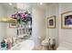 Stylish bathroom with granite countertop sink and decorative floral artwork at 7728 E Mary Sharon Dr, Scottsdale, AZ 85266