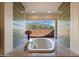 Relaxing bathroom featuring a large tub and scenic views of the desert landscape at 7728 E Mary Sharon Dr, Scottsdale, AZ 85266