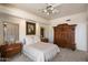 Comfortable bedroom with beautiful wood accents, a ceiling fan, and ample natural light at 7728 E Mary Sharon Dr, Scottsdale, AZ 85266