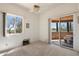 Empty bedroom with desert view, an outdoor patio, and plush carpet at 7728 E Mary Sharon Dr, Scottsdale, AZ 85266