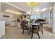 Bright dining room featuring a glass table, desert views, an open floor plan, and kitchen views at 7728 E Mary Sharon Dr, Scottsdale, AZ 85266