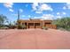 Desert home with a three-car garage, red brick driveway, and natural desert landscaping at 7728 E Mary Sharon Dr, Scottsdale, AZ 85266