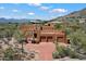 Exterior showcasing desert landscaping, driveway and a three car garage at 7728 E Mary Sharon Dr, Scottsdale, AZ 85266