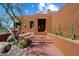 Desert home features a grand entrance, a small patio, and a unique xeriscaped yard with cacti at 7728 E Mary Sharon Dr, Scottsdale, AZ 85266